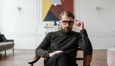 man wearing glasses and sitting in chair